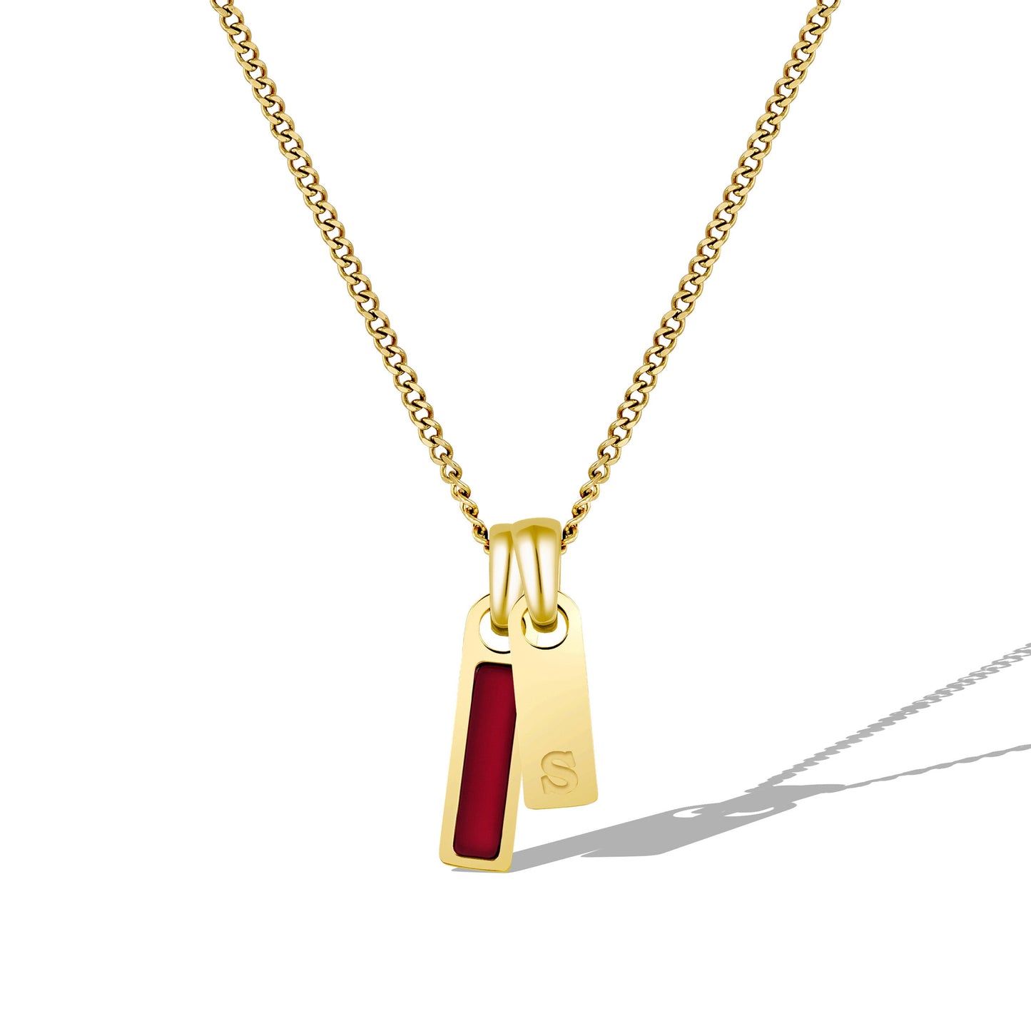 Gold necklace with a pendant featuring a red stone on a white background