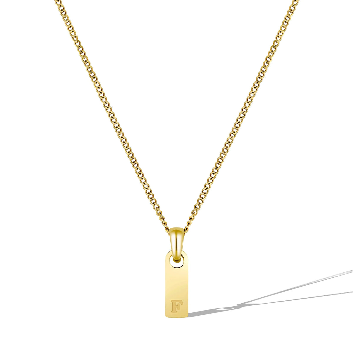 Gold necklace with a pendant featuring the letter 'F' on a white background